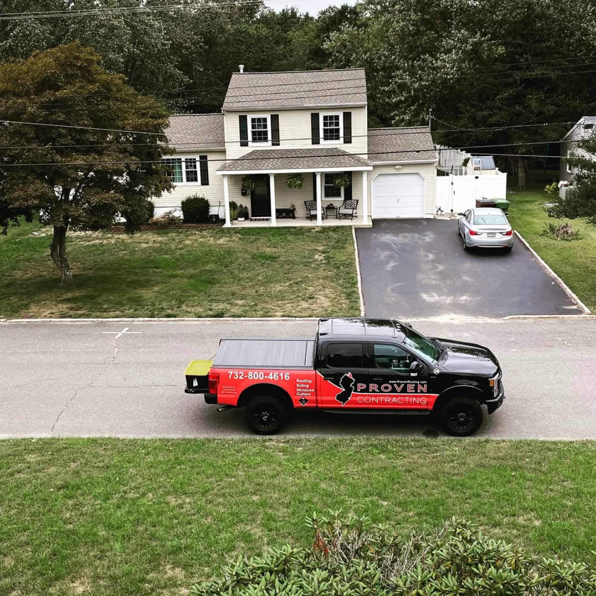 Proven Contracting service truck parked in front of a residential home in New Jersey
